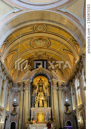 Baroque church interior with gilded altar ornate nave columns arches and ceiling fresco Lisbon Portugal. High quality photo 136065083