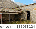 Traditional stone cottage exterior with wooden door clay tile roof and cobblestone street at Francisco and Lucia house complex Fatima Portugal. High quality photo 136065124