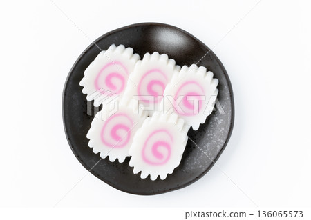 Sliced naruto rolls arranged on a plate on a white background Sliced naruto rolls arranged on a plate on a white background 136065573