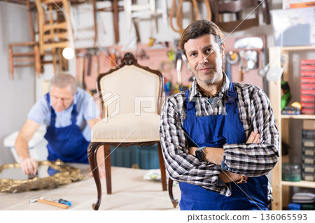 Confident male carpenter showing around local furniture workshop Confident male carpenter showing around local furniture workshop 136065593