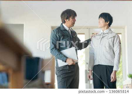 Men in work clothes having a meeting Men in work clothes having a meeting 136065814