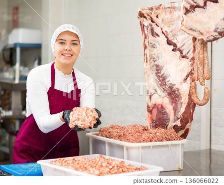 Young woman preparing minced meat in container Young woman preparing minced meat in container 136066022