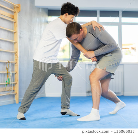 Man and boy teenager training self-defense techniques Man and boy teenager training self-defense techniques 136066035
