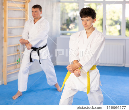 Man and boy teenager train karate technique 136066277