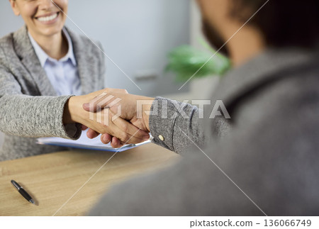 Handshake of business people at job interview, hiring agreement in office 136066749