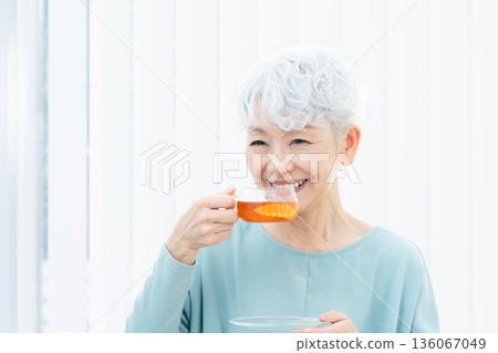 Senior woman drinking a hot drink 136067049