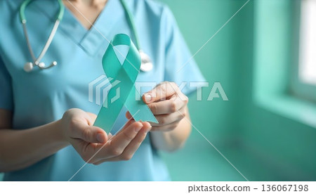 A nurse holds a teal ribbon, highlighting cervical cancer awareness and the fight for women's health and early detection 136067198