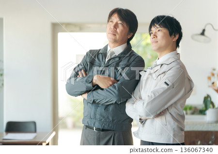 Men in work clothes with arms folded 136067340