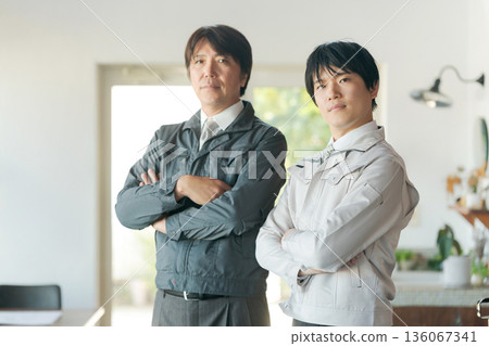 Men in work clothes with arms folded Men in work clothes with arms folded 136067341