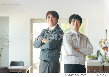 Men in work clothes with arms folded Men in work clothes with arms folded 136067347