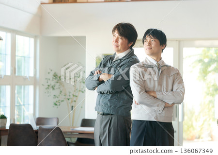 Men in work clothes with arms folded 136067349