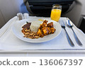 In-flight luxurious business class Asian meal of nasi lemak consisting rice and rendang chicken 136067397