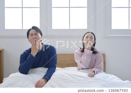 Couple in bed, sleep deprived Couple in bed, sleep deprived 136067593