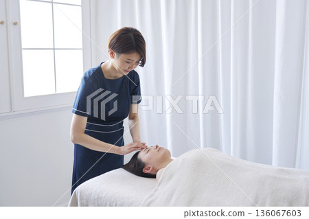 Female esthetician facial beauty treatment 136067603