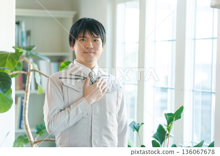 young man in work clothes young man in work clothes 136067678