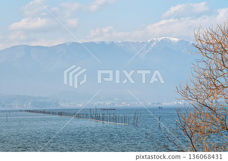 Fishing on Lake Biwa, hazy with yellow sand, and snow-covered Mount Hira Fishing on Lake Biwa, hazy with yellow sand, and snow-covered Mount Hira 136068431