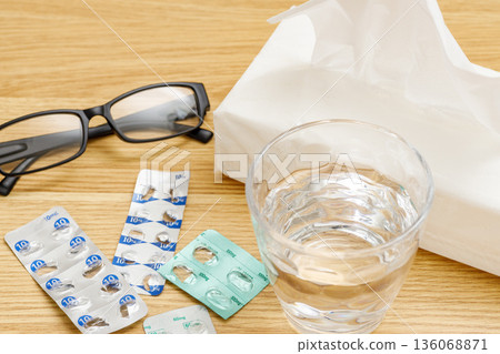 Hay fever | Glasses, water, medicine packaging, tissues Hay fever | Glasses, water, medicine packaging, tissues 136068871