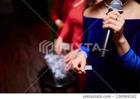 Individuals involved are dressed suitably and ready for ceremony activities, All attendees and organizers are appropriately dressed and prepared for formal gathering 136069162