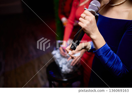 Individuals involved are dressed suitably and ready for ceremony activities, All attendees and organizers are appropriately dressed and prepared for formal gathering 136069163