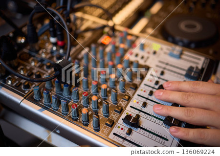 Engineer finetuning sound signals using patch cables, Focused technician adjusting levels on electronic patch cable setup with vivid colorful plugs and tactile interfaces Engineer finetuning sound signals using patch cables, Focused technician adjusting levels on electronic patch cable setup with vivid colorful plugs and tactile interfaces 136069224