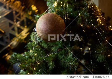 Seasonal decorations featuring shimmering details and warmth, Decorative seasonal motifs highlighting glittering textures amidst cheerful and glowing holiday surroundings 136069243