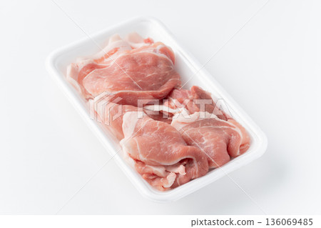 Raw pork thigh trimmings in a food tray on a white background Raw pork thigh trimmings in a food tray on a white background 136069485