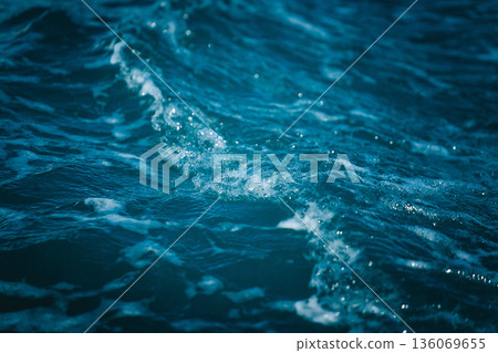 Marine water reflection, Ocean waves with gentle shimmer, Calm sea surface displaying ripples and highlights, Closeup of ocean waves reflecting light with textured tranquility 136069655