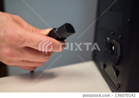 Person connecting audio cable indoors, Closeup of hand attaching cable to speaker port, Individual securing audio cable to speaker during casual home electronics installation Person connecting audio cable indoors, Closeup of hand attaching cable to speaker port, Individual securing audio cable to speaker during casual home electronics installation 136070142