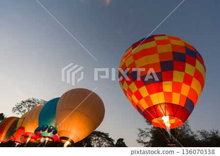 colorful hot air balloons glowing against sky 136070338