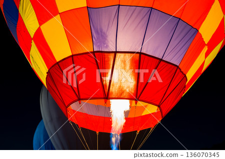 colorful hot air balloons glowing against the night sky 136070345