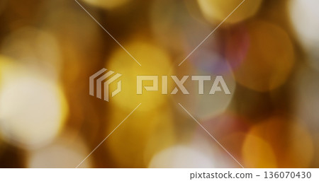 Defocused glow circles. Vibrant yellow light. Orange purple color round bright texture glimmer gleam reflection on abstract bokeh background. Defocused glow circles. Vibrant yellow light. Orange purple color round bright texture glimmer gleam reflection on abstract bokeh background. 136070430