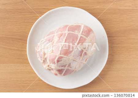 Pork leg ham wrapped in string on a plate 136070814