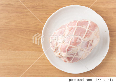 Pork leg ham wrapped in string on a plate 136070815