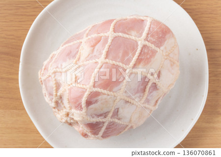 Close-up of pork leg ham wrapped in string on a plate Close-up of pork leg ham wrapped in string on a plate 136070861