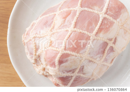 Close-up of pork leg ham wrapped in string on a plate Close-up of pork leg ham wrapped in string on a plate 136070864
