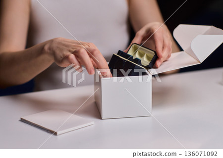 Professional microphone placement process. Technician carefully arranges microphone on desk. Precise setup of audio equipment for broadcasting or retail display 136071092