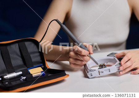 Precise fan motor wiring craft, Closeup of careful electrical soldering work, Meticulous assembly of fan motor components through precision soldering and careful alignment Precise fan motor wiring craft, Closeup of careful electrical soldering work, Meticulous assembly of fan motor components through precision soldering and careful alignment 136071131