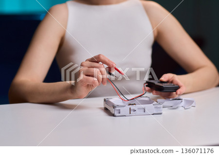 Meticulous technician conducts detailed inspection of fan wiring connectivity, Focused technician meticulously tests and inspects fan motor connections with precision and care 136071176