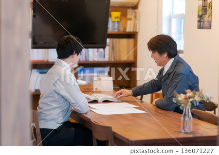 Men in work clothes having a meeting Men in work clothes having a meeting 136071227