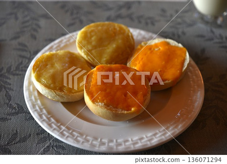 Cheddar and Leicester on bun on white plate. 136071294