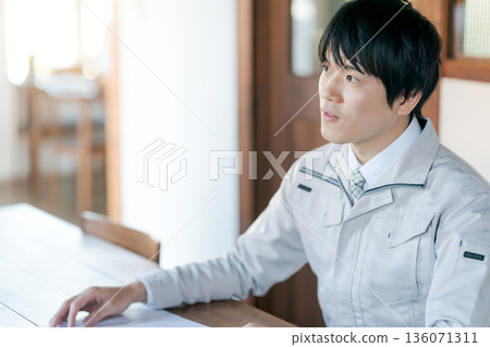 Men in work clothes having a meeting Men in work clothes having a meeting 136071311