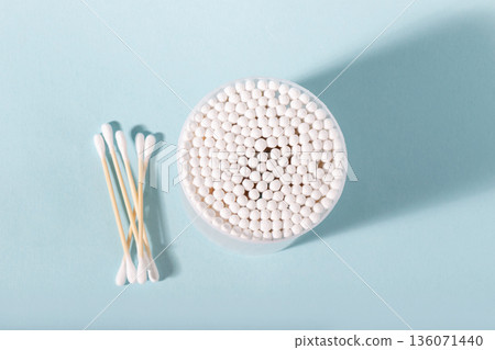 Cotton swabs in container with loose ones for hygiene Cotton swabs in container with loose ones for hygiene 136071440