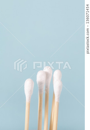 Cotton swabs for hygiene and grooming on blue background Cotton swabs for hygiene and grooming on blue background 136071454