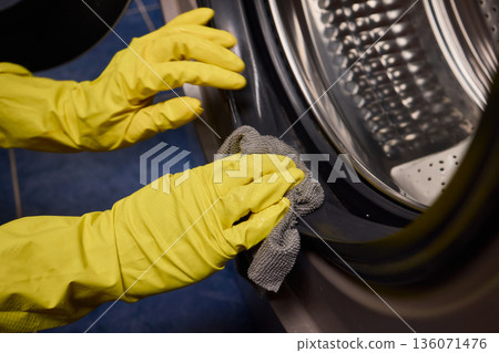 Using gloves to clean and protect gasket seals from mold, Thoroughly maintain gasket surfaces by sanitizing with cloth and hand wiping to prevent mold and moisture buildup 136071476