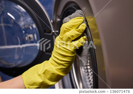 Using gloves to clean and protect gasket seals from mold, Thoroughly maintain gasket surfaces by sanitizing with cloth and hand wiping to prevent mold and moisture buildup 136071478