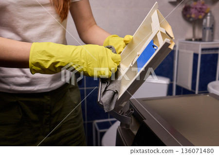 Checking detergent drawer for residue, Detailed view of appliance maintenance steps, Closeup of hands checking for limescale and residue in household appliance drawer Checking detergent drawer for residue, Detailed view of appliance maintenance steps, Closeup of hands checking for limescale and residue in household appliance drawer 136071480