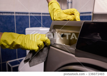 Using gloves to clean and protect gasket seals from mold, Thoroughly maintain gasket surfaces by sanitizing with cloth and hand wiping to prevent mold and moisture buildup 136071483
