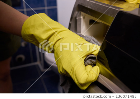 Using gloves to clean and protect gasket seals from mold, Thoroughly maintain gasket surfaces by sanitizing with cloth and hand wiping to prevent mold and moisture buildup 136071485