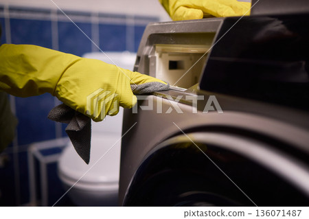 Using gloves to clean and protect gasket seals from mold, Thoroughly maintain gasket surfaces by sanitizing with cloth and hand wiping to prevent mold and moisture buildup 136071487