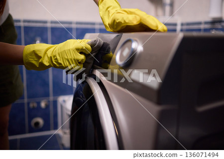 Using gloves to clean and protect gasket seals from mold, Thoroughly maintain gasket surfaces by sanitizing with cloth and hand wiping to prevent mold and moisture buildup 136071494
